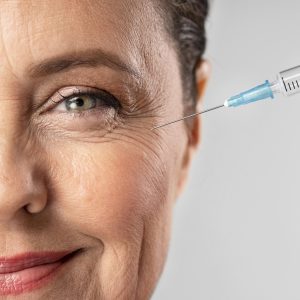 smiley-elder-woman-using-injection-her-eye-wrinkles smiley-elder-woman-using-injection-her-eye-wrinkles